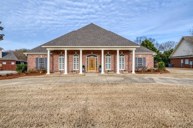 view of front facade with central AC unit and covered porch