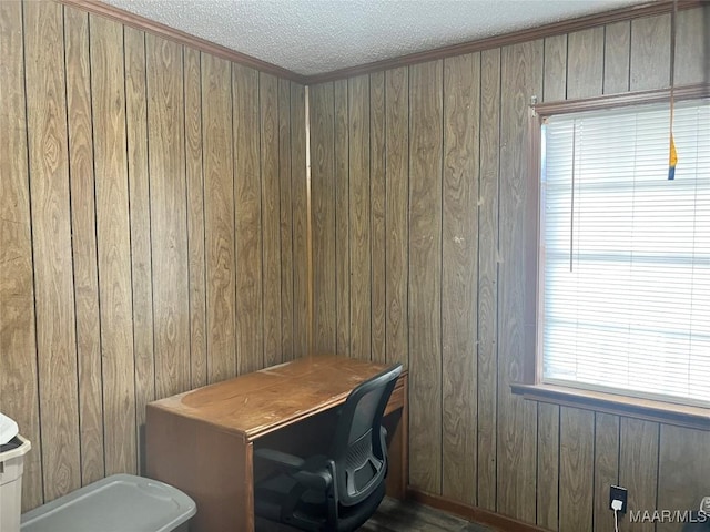 office space featuring wooden walls and a textured ceiling