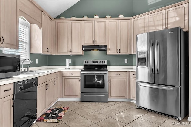 kitchen with stainless steel appliances, sink, light tile patterned floors, and light brown cabinetry