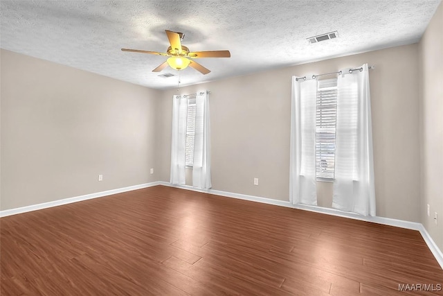 unfurnished room with hardwood / wood-style floors, a textured ceiling, and ceiling fan