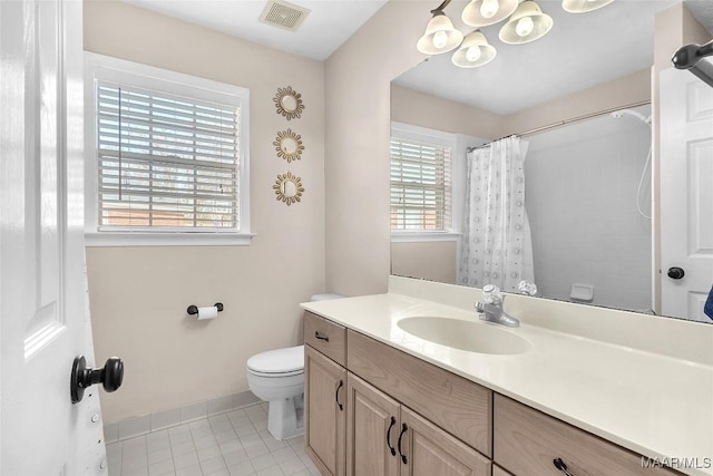 bathroom with tile patterned flooring, vanity, curtained shower, and toilet