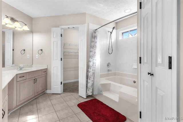 bathroom with tile patterned flooring, vanity, shower / bathtub combination with curtain, and a textured ceiling