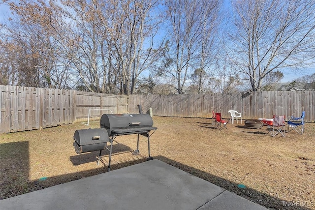 view of yard featuring a patio area and an outdoor fire pit