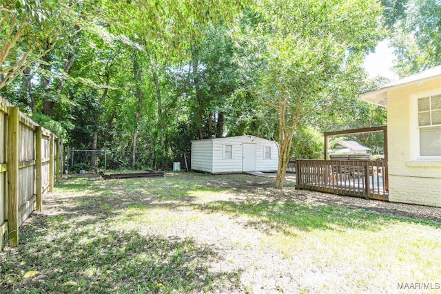 view of yard with a wooden deck and a shed