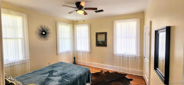 bedroom with wood-type flooring and ceiling fan