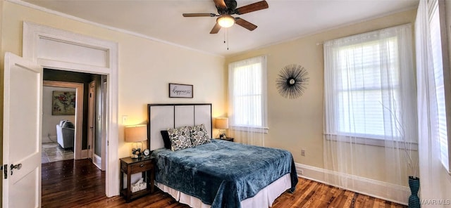 bedroom with dark wood-type flooring, ceiling fan, and ornamental molding