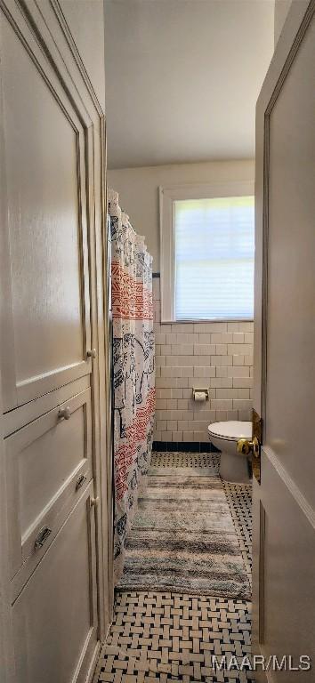 bathroom with toilet and tile patterned flooring