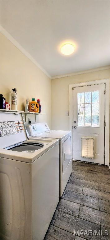 washroom with dark hardwood / wood-style flooring, washer and clothes dryer, and ornamental molding