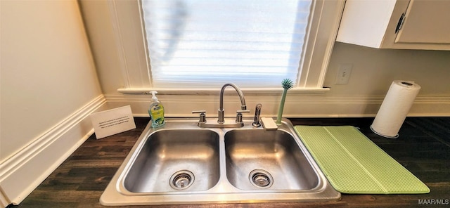 interior details featuring sink and white cabinets