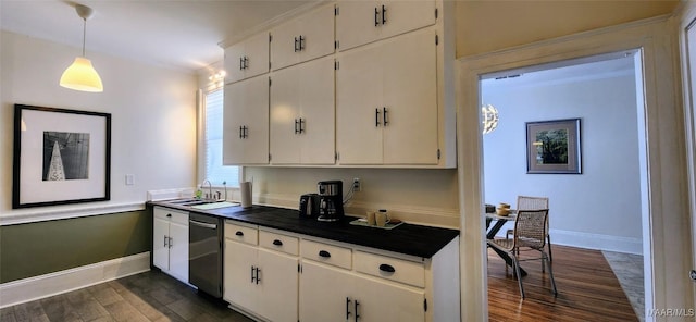 kitchen featuring pendant lighting, sink, dark wood-type flooring, dishwasher, and white cabinets