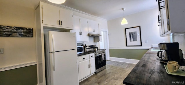 kitchen with butcher block countertops, hanging light fixtures, hardwood / wood-style flooring, stainless steel appliances, and white cabinets