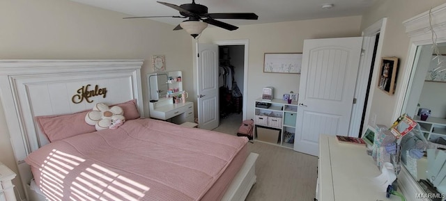 bedroom with ceiling fan, a closet, and a walk in closet