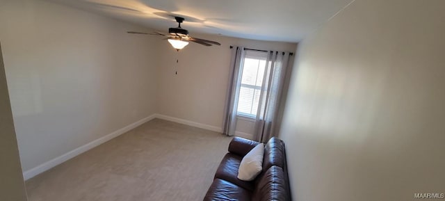 carpeted spare room featuring ceiling fan