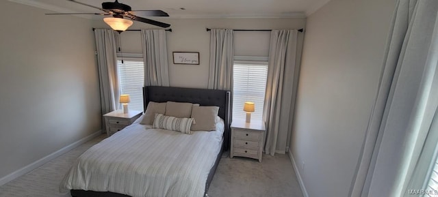 carpeted bedroom with ceiling fan and ornamental molding