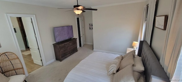 bedroom featuring crown molding, light wood-type flooring, and ceiling fan