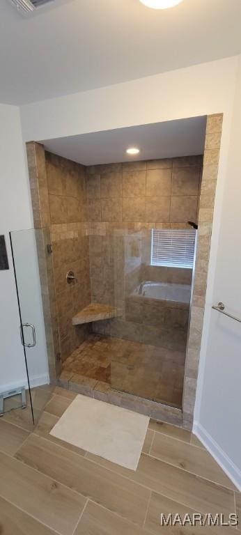 bathroom featuring independent shower and bath