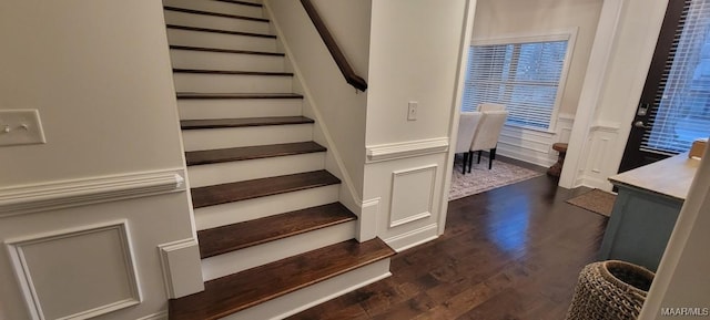 stairs featuring hardwood / wood-style floors