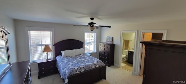 carpeted bedroom featuring connected bathroom and ceiling fan