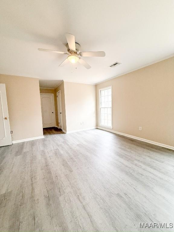 empty room with ceiling fan and light wood-type flooring