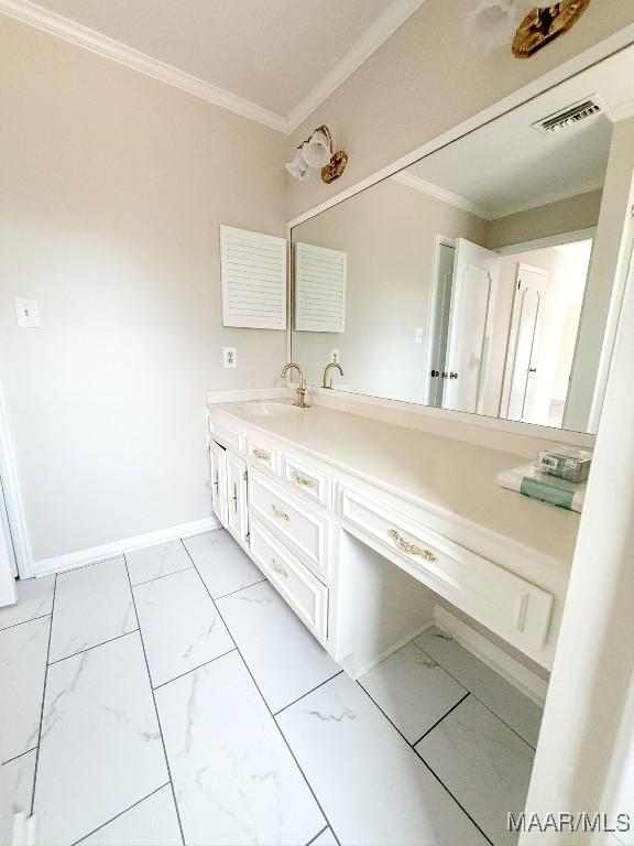 bathroom featuring crown molding and vanity