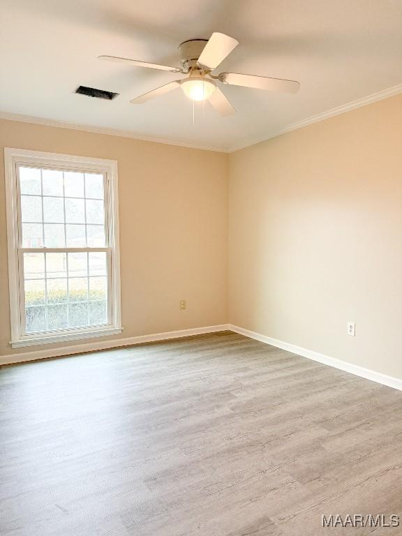 empty room with crown molding, ceiling fan, and light hardwood / wood-style floors