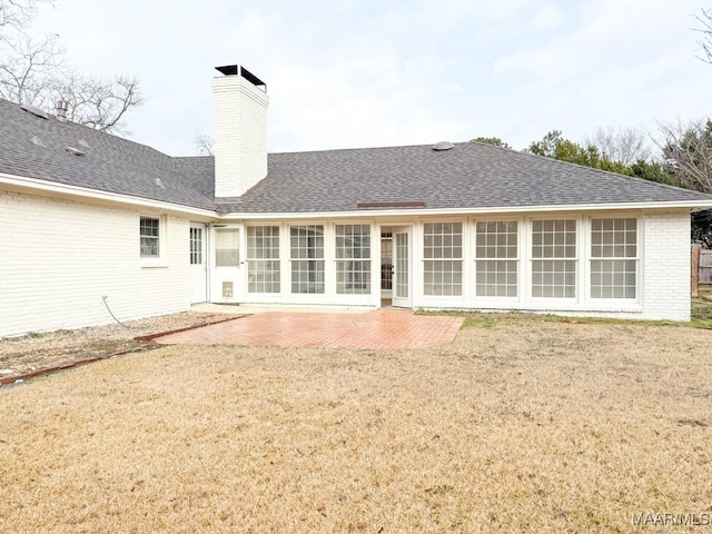 back of house featuring a patio area and a lawn