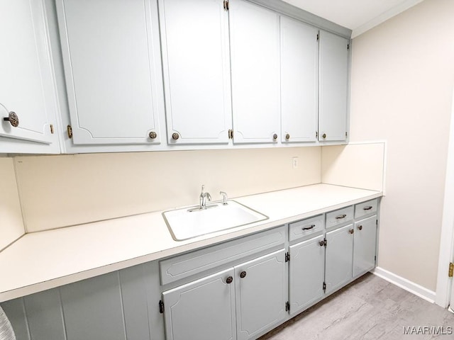 interior space featuring sink and light hardwood / wood-style flooring