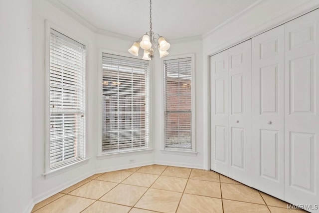 unfurnished dining area featuring ornamental molding, light tile patterned floors, and an inviting chandelier