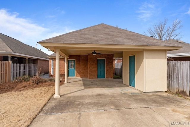 rear view of property featuring ceiling fan