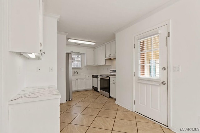 kitchen with white cabinetry, sink, stainless steel appliances, and light tile patterned flooring