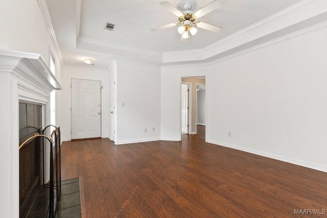 unfurnished living room with ceiling fan, ornamental molding, dark hardwood / wood-style floors, and a raised ceiling