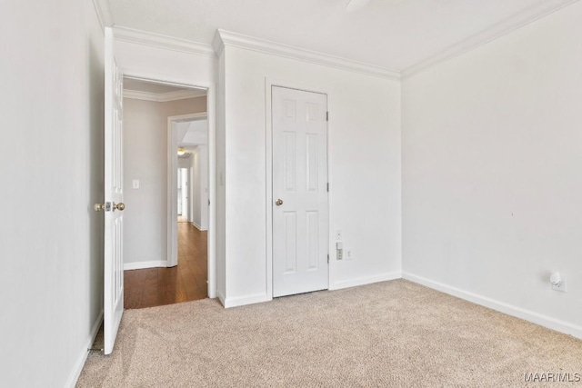 unfurnished bedroom with crown molding and carpet