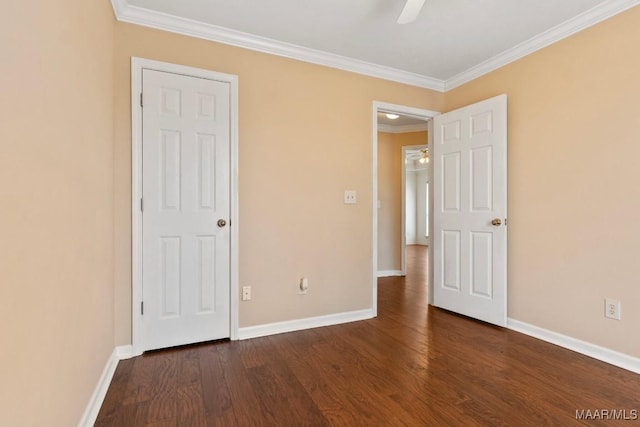 unfurnished bedroom with dark wood-type flooring, ornamental molding, and ceiling fan