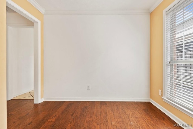 empty room with crown molding, wood-type flooring, and a wealth of natural light