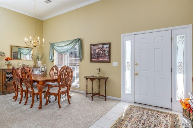 carpeted dining area with crown molding, a chandelier, and a high ceiling