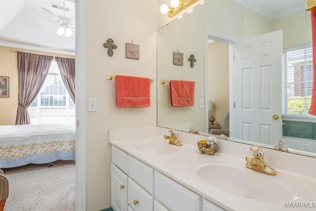 bathroom featuring vanity, crown molding, and ceiling fan