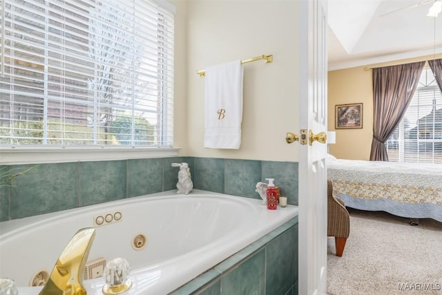 bathroom with crown molding and tiled bath