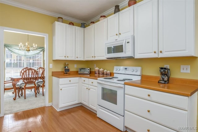 kitchen featuring white cabinetry, a chandelier, ornamental molding, light hardwood / wood-style floors, and white appliances