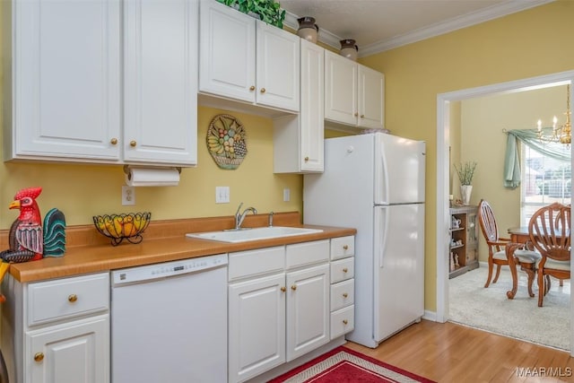 kitchen featuring sink, white cabinets, ornamental molding, white appliances, and light hardwood / wood-style flooring