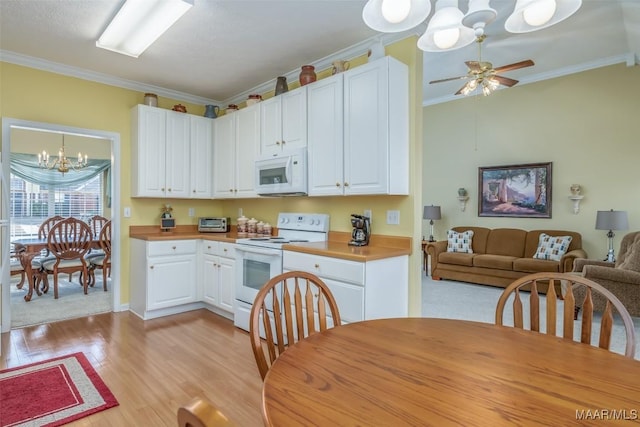 kitchen with ornamental molding, light wood-type flooring, white cabinets, and white appliances