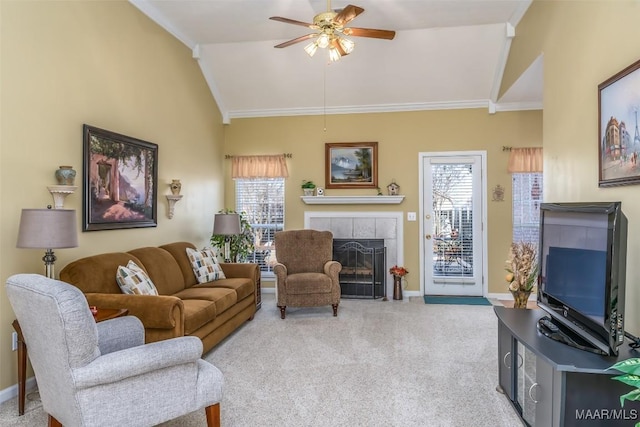 living room featuring ceiling fan, a healthy amount of sunlight, light carpet, and a fireplace