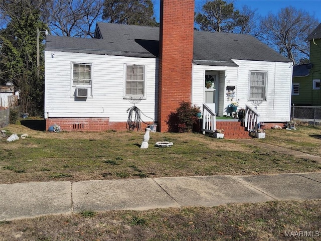 view of front of house with cooling unit and a front yard