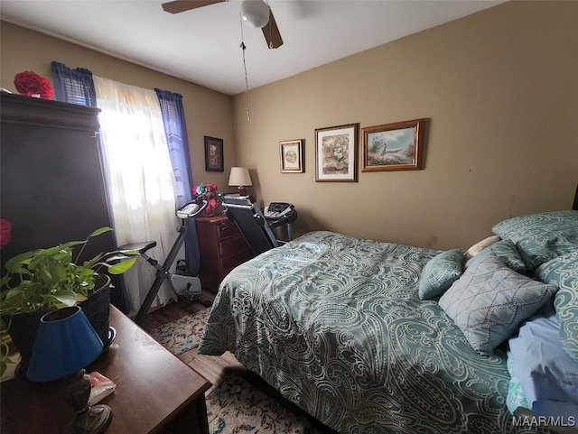 bedroom featuring hardwood / wood-style flooring and ceiling fan