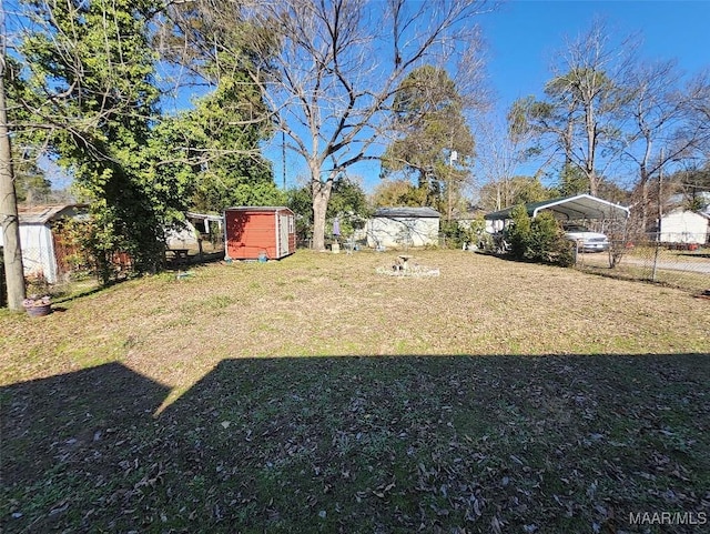 view of yard featuring a carport and a shed