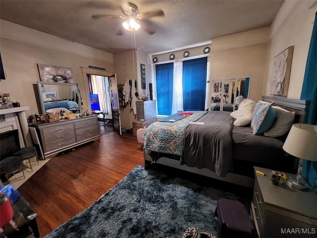 bedroom with dark hardwood / wood-style floors and ceiling fan