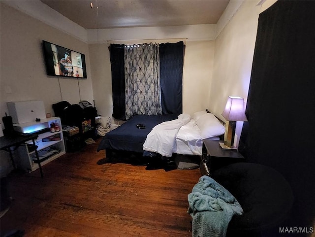 bedroom with hardwood / wood-style flooring