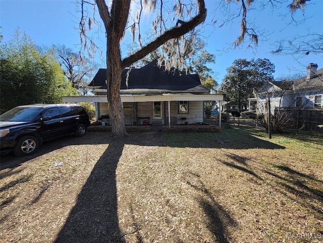 back of house featuring a porch and a yard