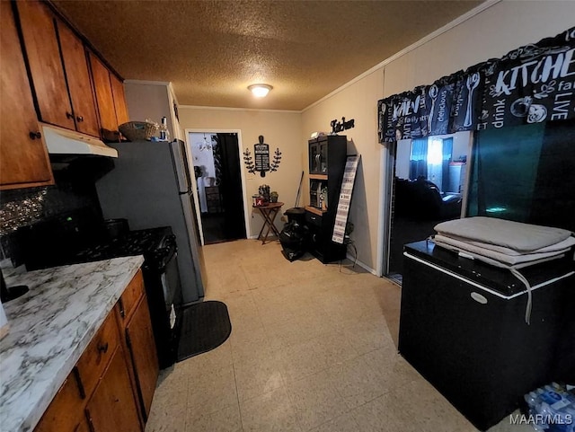 kitchen featuring crown molding, a textured ceiling, and black stove