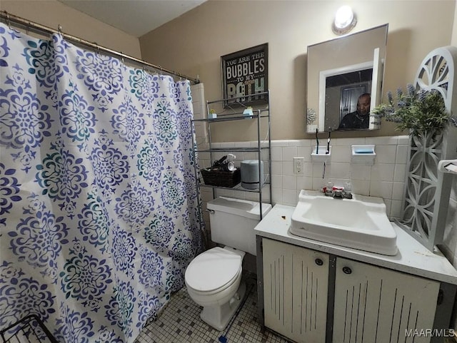 bathroom with toilet, tile walls, vanity, a shower with shower curtain, and tile patterned flooring