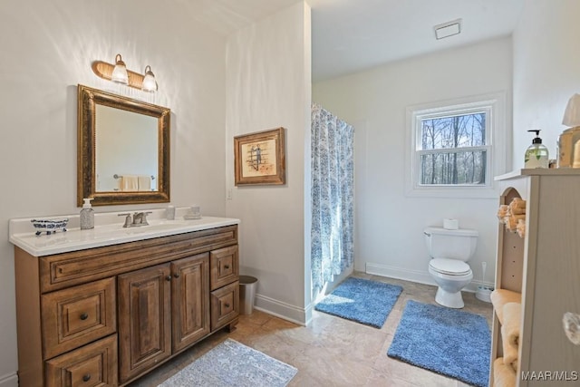 bathroom with tile patterned flooring, vanity, a shower with shower curtain, and toilet